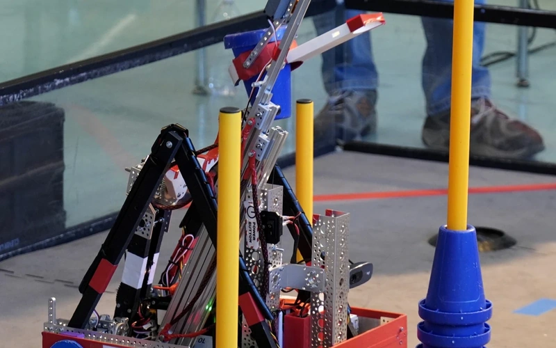 FTC robot competing on a field with cone scoring elements