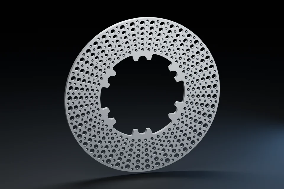 Perforated cast-iron brake rotor before heating.