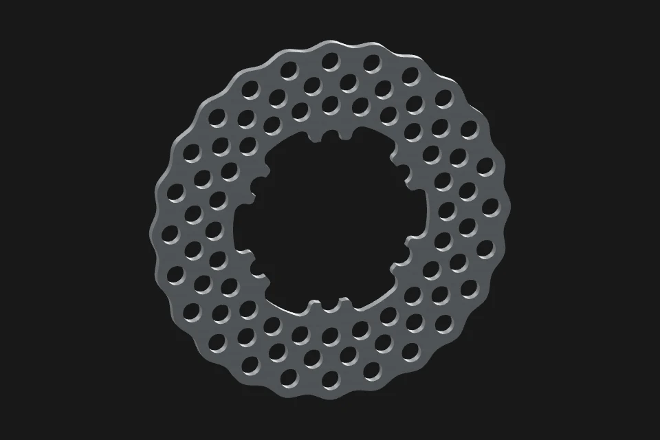 Perforated cast-iron brake rotor before heating.