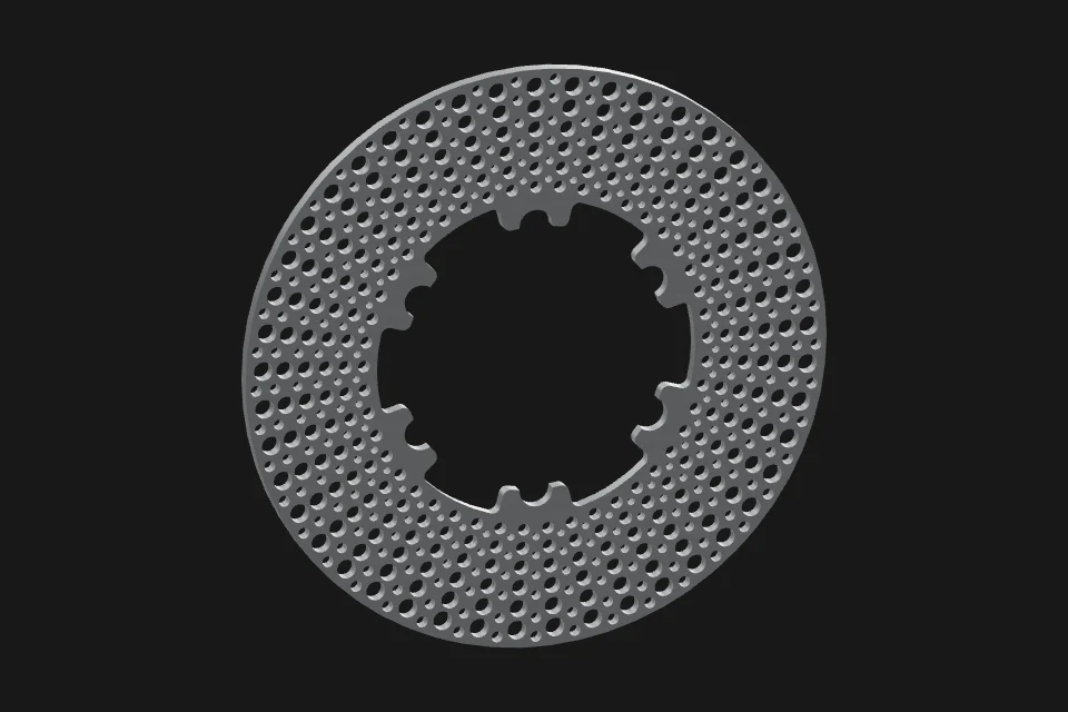 Perforated cast-iron brake rotor before heating.